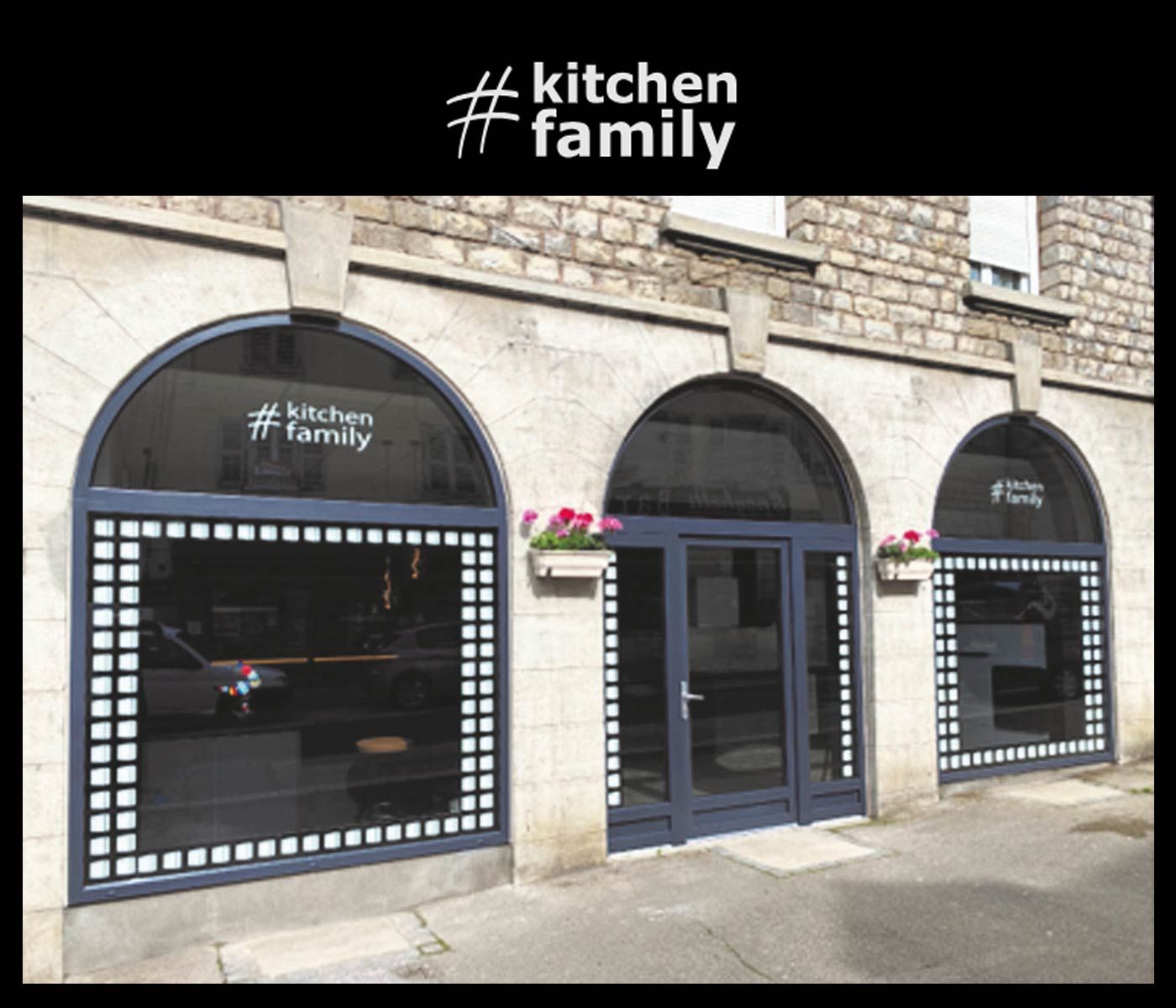 Kitchen Family Storefront Stone building facade with arched windows and "#kitchenfamily" branding.